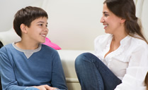 Boy and his mother sitting on the floor of the living room