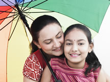 Mother and daughter under an umbrella