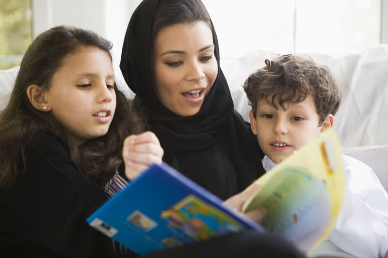 Mother reading with her daughter and son